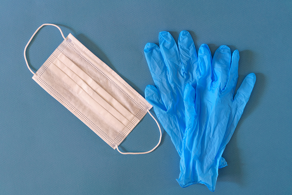 Medical mask and gloves on a blue background Machingo