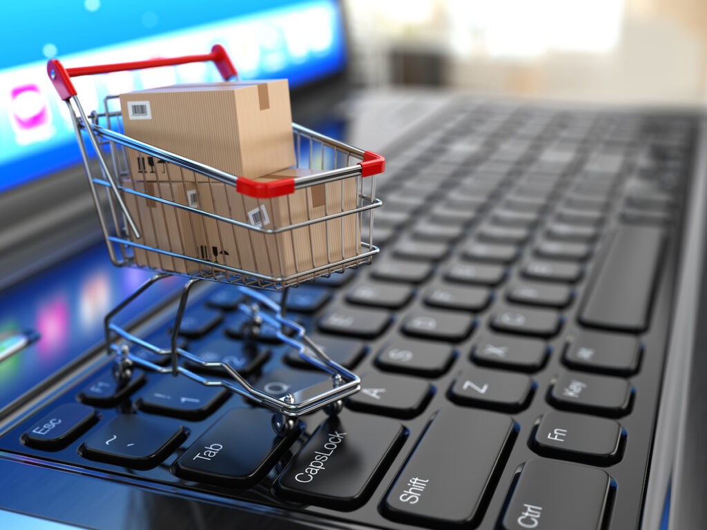 EcommerceShoppingCartWithCardboardBoxesOnLaptop3d Machingo