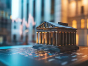 Bronze miniature classical temple model on a dark desk with blurred city lights in the background.