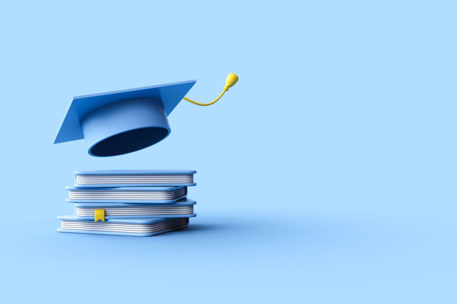Blue graduation cap perched on a stack of textbooks against a blue backdrop, symbolizing education and achievement.
