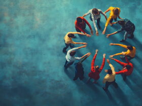Overhead view of a diverse group forming a circle, hands joined in the center to symbolize teamwork.