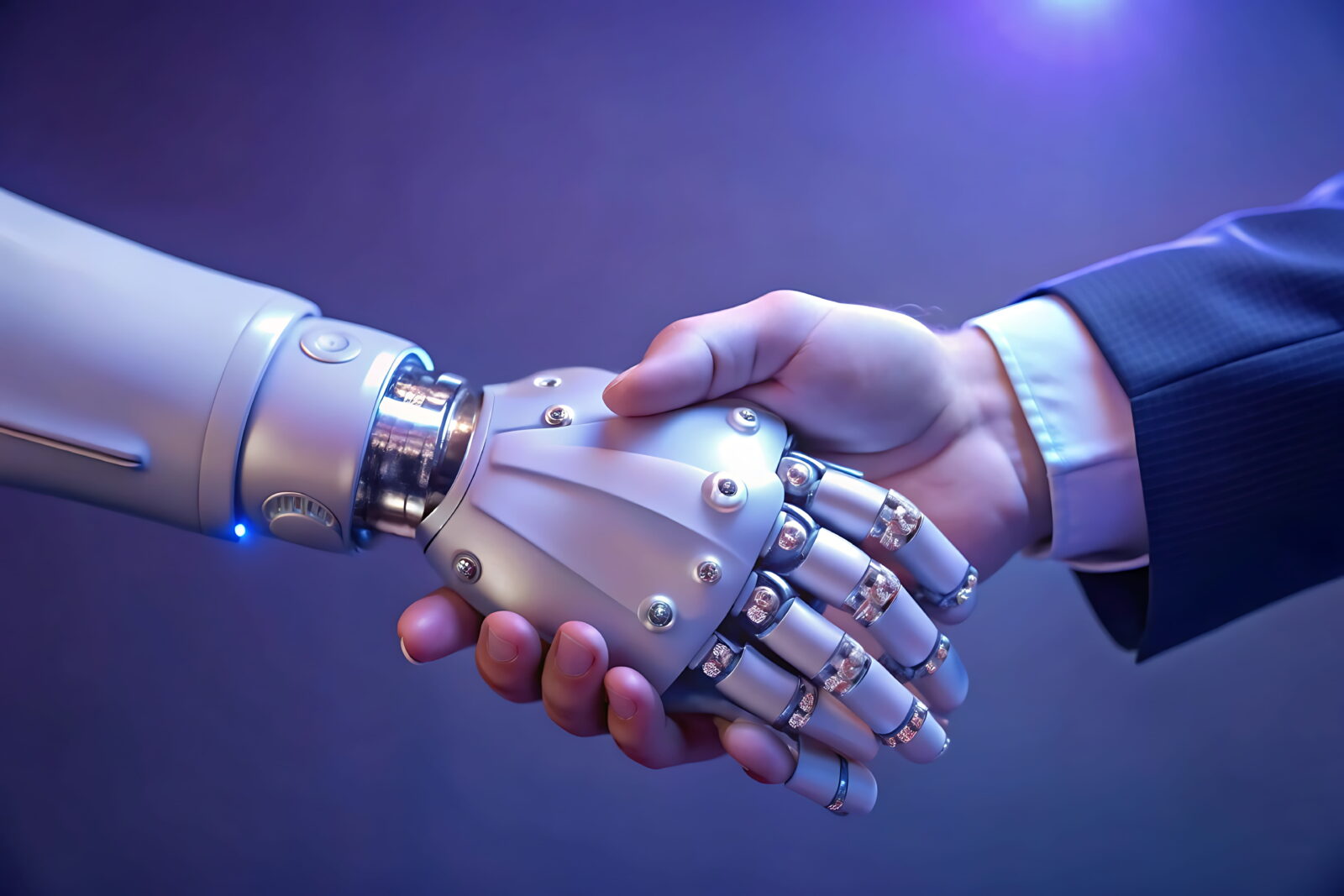 Handshake between a human hand and a robotic hand in blue lighting, symbolizing human-robot collaboration.