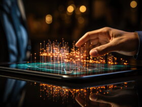 A hand hovers over a tablet displaying a glowing, hologram-like network of orange light pins rising from the screen.